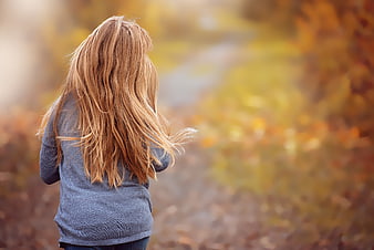 Woman Running In Autumn Forest With Long Blonde Hair