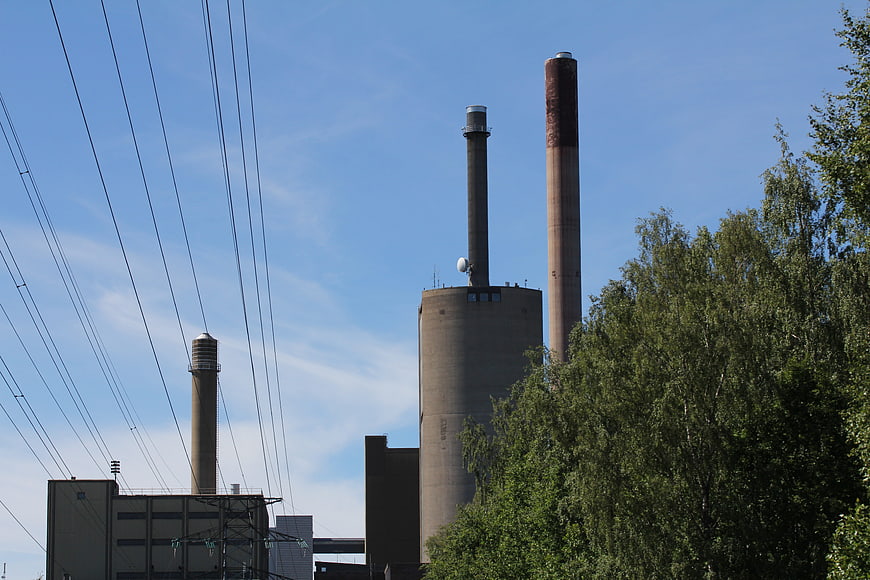 Industrial power plant chimneys against blue sky