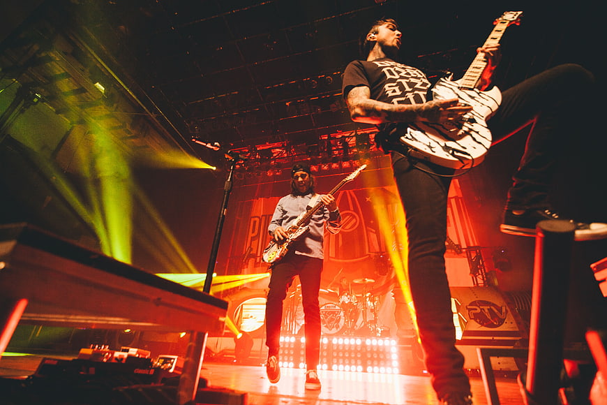 Rock band performing live on stage with electric guitars