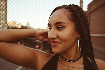 Stylish Woman with Braids Smiling Outdoors