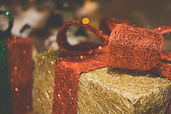 Close-up of Glittery Gold and Red Christmas Gift Wrapping
