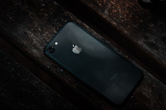 Black iPhone on Dark Wooden Surface