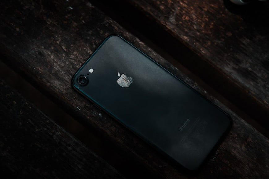 Black iPhone on Dark Wooden Surface
