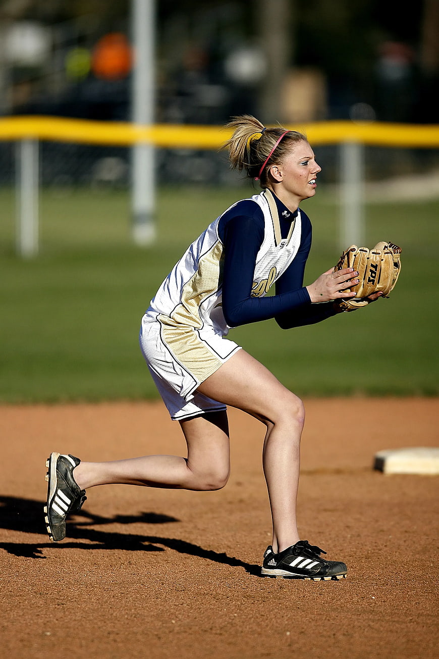 Female Softball Player Fielding on Dirt Infield
