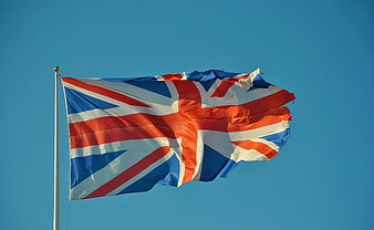 Union Jack Flag Waving Against Clear Blue Sky