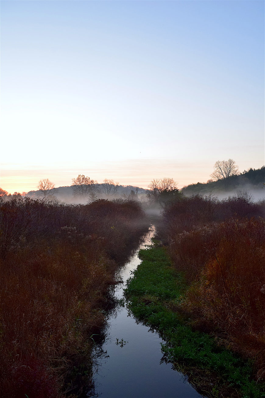 Misty Autumn Stream at Sunrise with Foggy Landscape