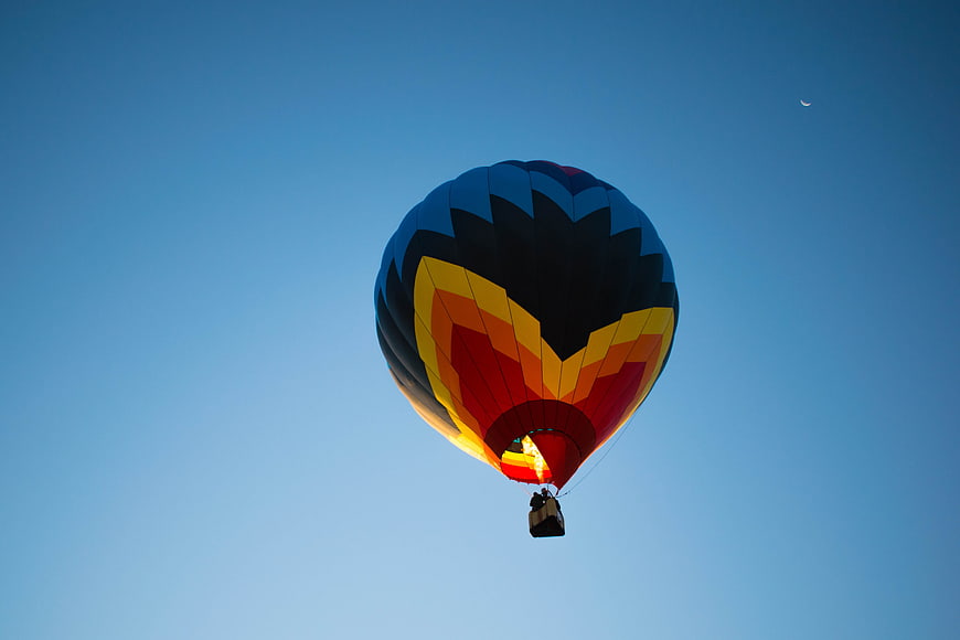 Colorful Hot Air Balloon Flying Against Blue Sky