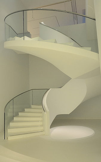 Modern white spiral staircase with glass railing