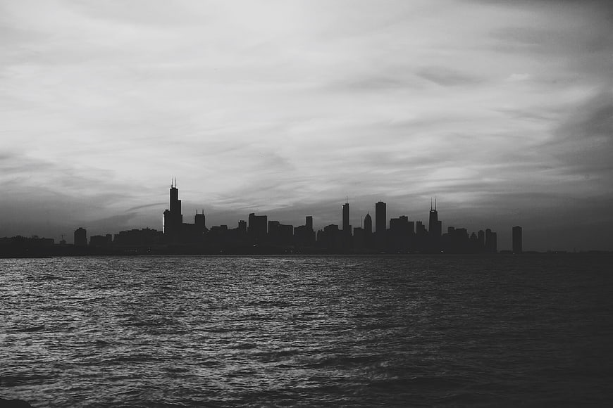 Moody Black and White Chicago Skyline Silhouette Over Lake