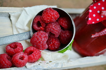 Fresh Raspberries in Metal Scoop with Jam Jar