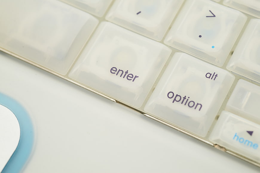 Close-up of white computer keyboard keys with enter and option
