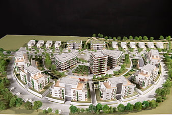 Architectural model of modern residential complex with green spaces
