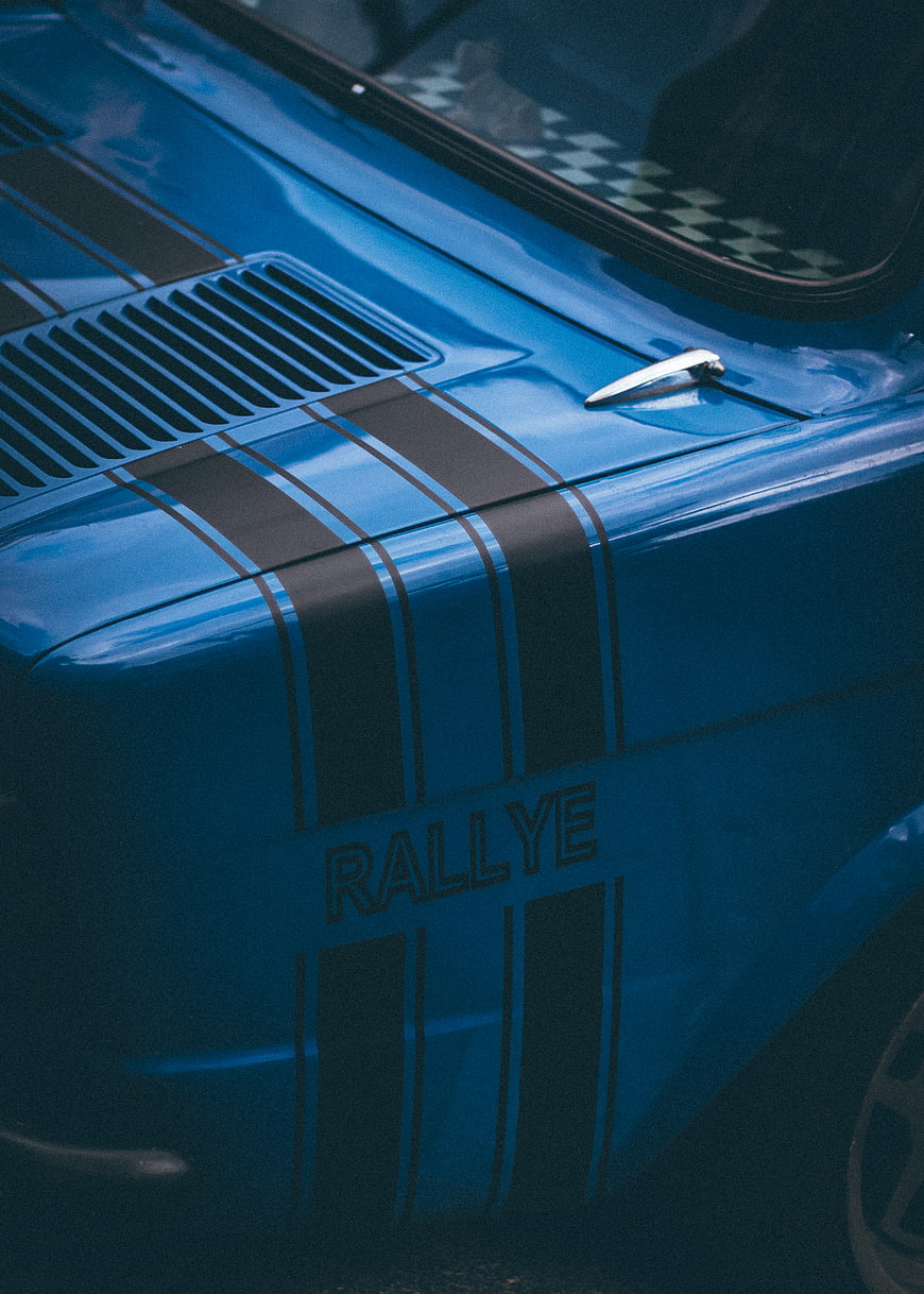 Close-up of blue vintage rally car with black racing stripes