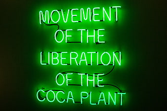 Green Neon Sign Reading Movement of the Liberation of the Coca Plant