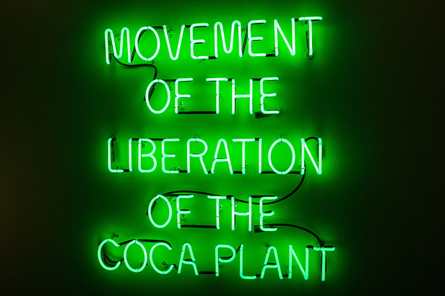 Green Neon Sign Reading Movement of the Liberation of the Coca Plant