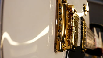 Close-up of White Electric Guitar with Gold Hardware