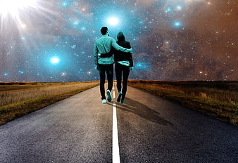 Couple walking down road under starry galaxy sky