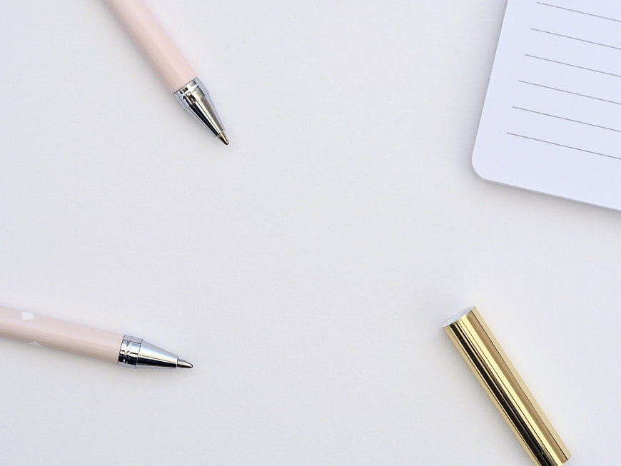 Minimalist Pink Pens and Gold Cap on White Desk