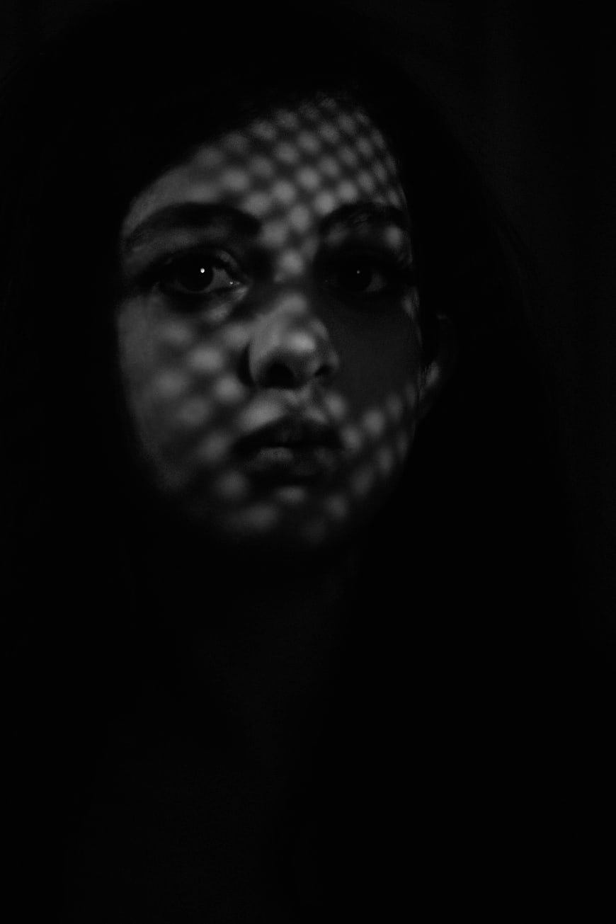 Moody Black and White Portrait of Woman with Grid Shadows