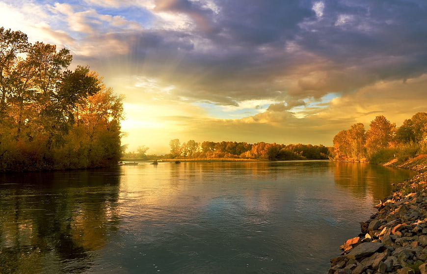 Golden Autumn Sunset Over a Serene River Landscape