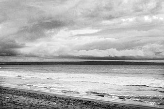 Dramatic Black and White Ocean Beach with Stormy Clouds