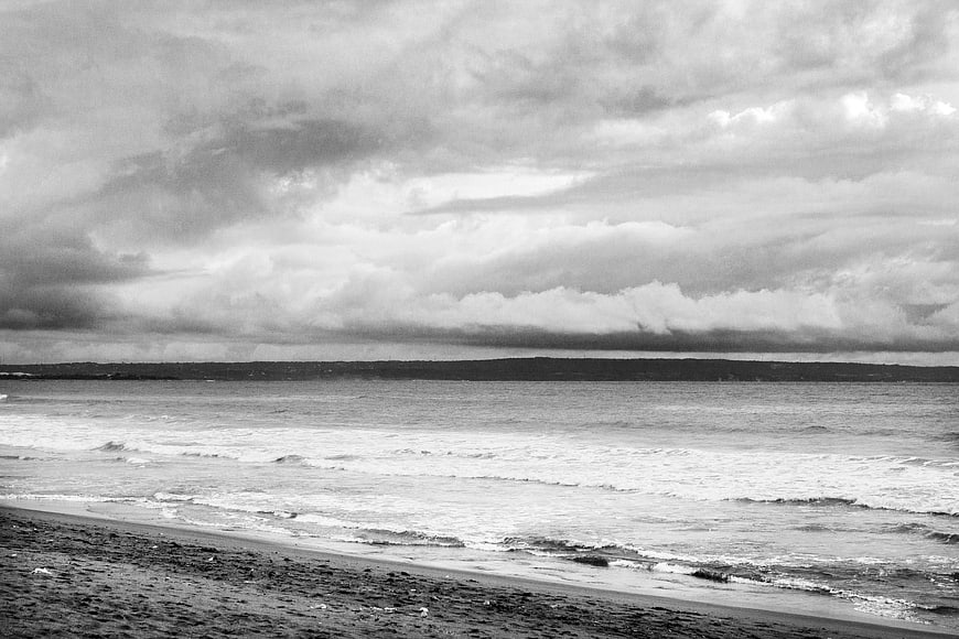 Dramatic Black and White Ocean Beach with Stormy Clouds