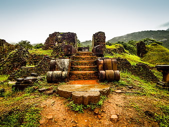 Ancient brick temple ruins in Vietnam with stone naga balustrades