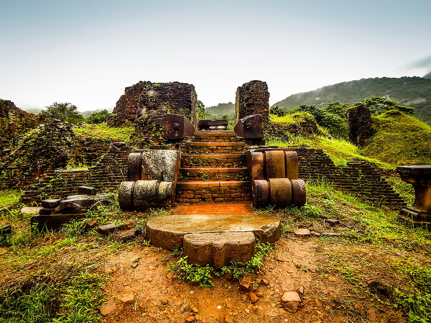 Ancient brick temple ruins in Vietnam with stone naga balustrades