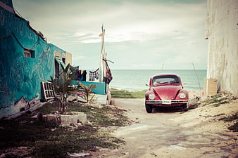Vintage Red VW Beetle Parked on Coastal Road