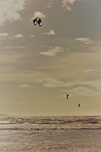 Kiteboarder Jumping High Over Ocean Waves