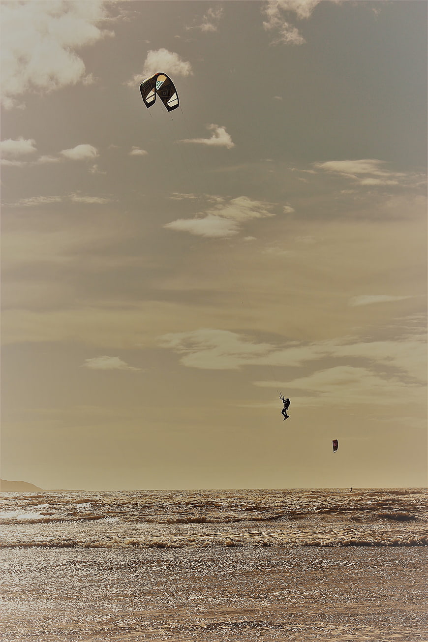 Kiteboarder Jumping High Over Ocean Waves