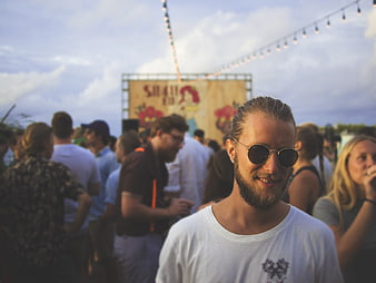 Smiling man with sunglasses at outdoor music festival