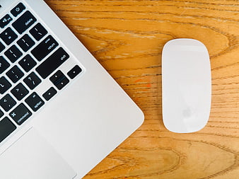 Top View of Laptop and Mouse on Wooden Desk