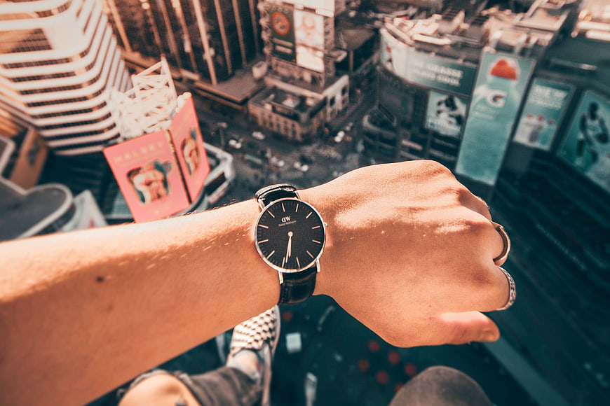 Man Checking Watch With City View