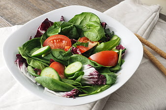 Fresh Green Salad with Tomatoes and Cucumbers in White Bowl