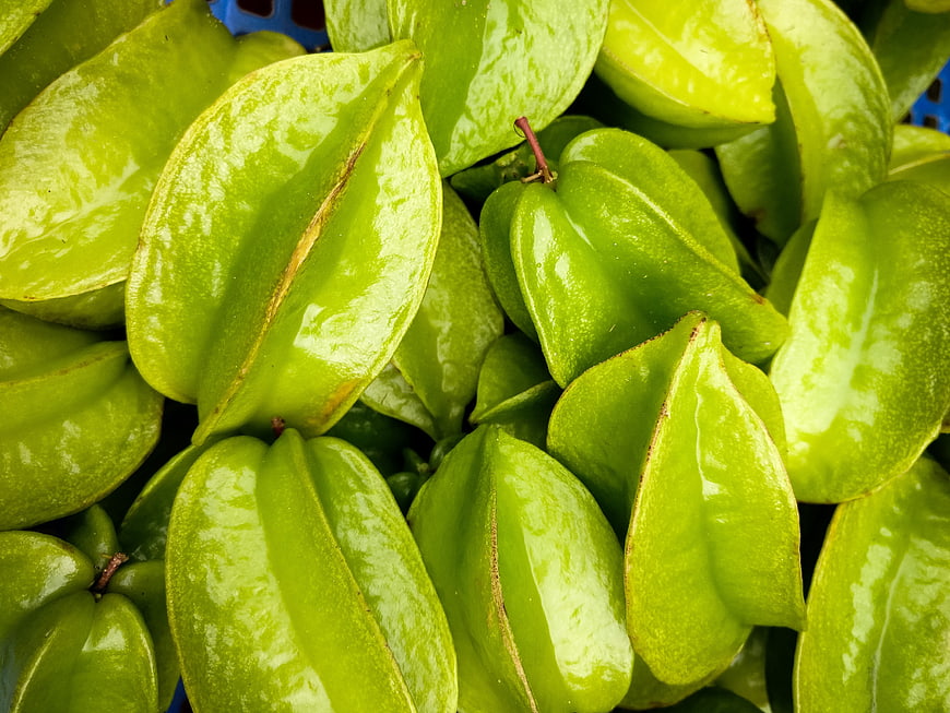 Close-up of fresh green star fruit in a pile