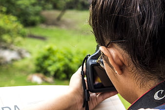 Photographer Taking Photo with DSLR Camera Outdoors