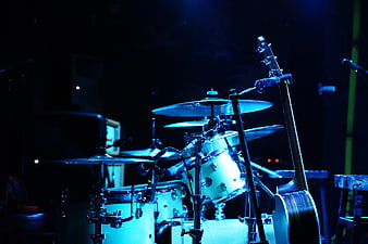 Drum Kit And Bass Guitar On Stage Under Blue Lighting