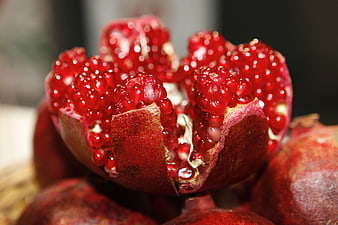 Close-up of Fresh Ripe Pomegranate with Red Arils