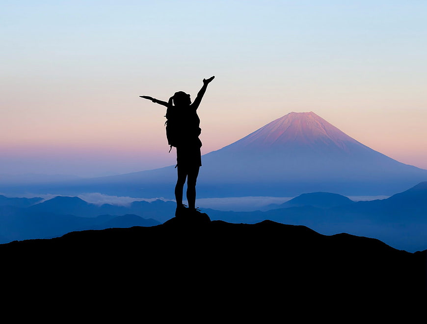 Silhouette of Hiker Celebrating with Mount Fuji Background