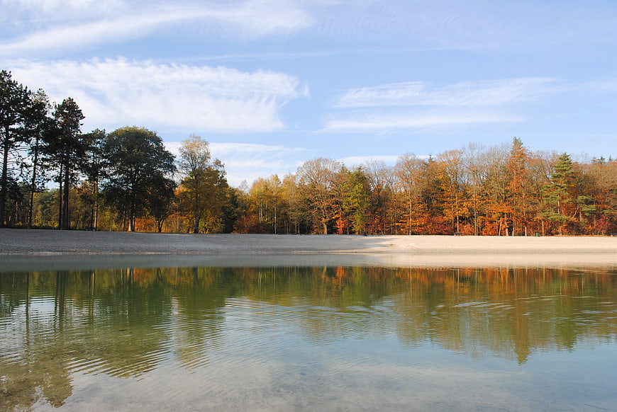 Serene autumn lake with colorful forest reflections