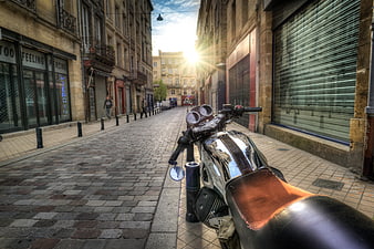 Vintage motorcycle parked on cobblestone European street