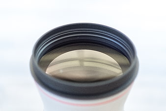 Close-up of Camera Lens Front Element on White Background