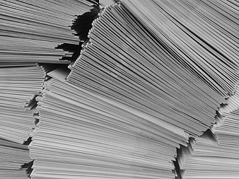 Stacks of white envelopes and paper documents