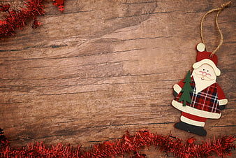 Rustic Wooden Santa Claus Ornament on Wood Background
