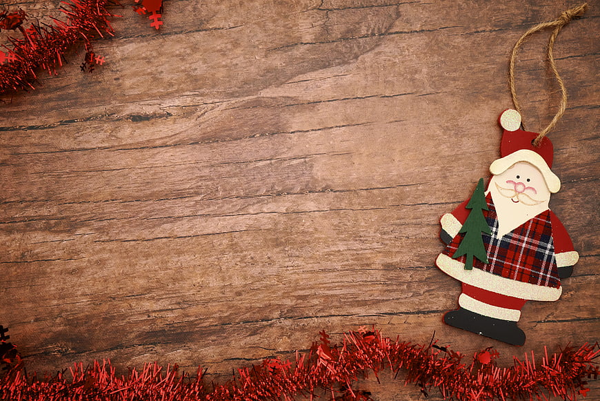 Rustic Wooden Santa Claus Ornament on Wood Background
