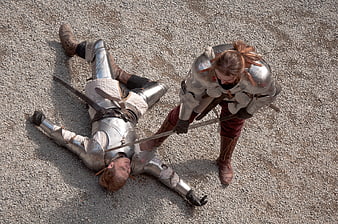 Two Knights In Full Plate Armor Engaged In Historical Sword Combat