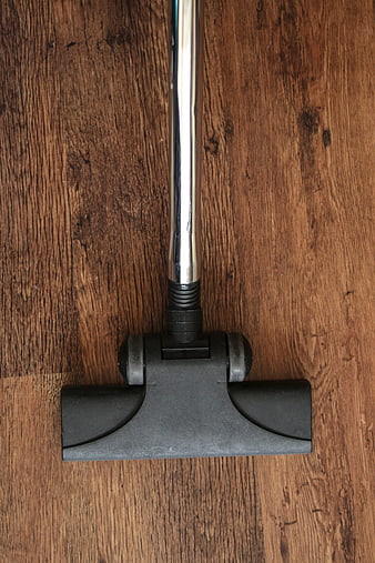 Top view of vacuum cleaner head on wooden floor