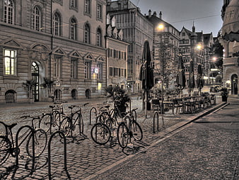 Cobblestone street in Freiburg, Germany with parked bicycles at dawn