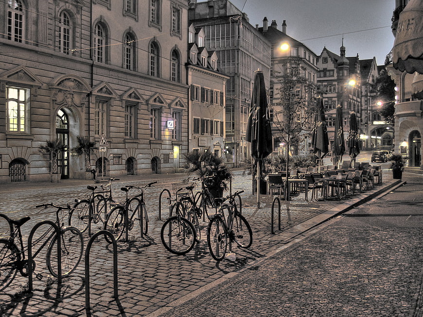 Cobblestone street in Freiburg, Germany with parked bicycles at dawn